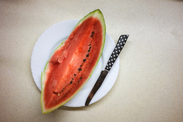 A piece of watermelon on the kitchen table