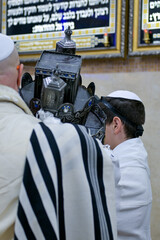 A Bar Mitzvah boy and his father standing by the Torah ark