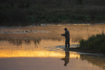 fishermen on the river with fishing rod
