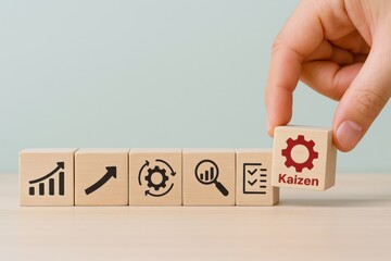 Kaizen Improvement Process with Wooden Blocks Displaying Icons Representing Growth, Analysis, and Continuous Improvement