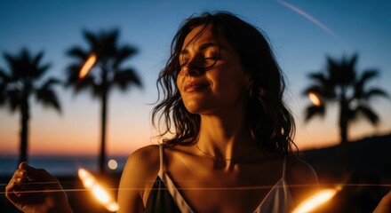 A woman is centered against a twilight backdrop of palm trees, eyes closed. She wears a tank top and is illuminated by warm light flares.

