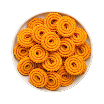 Delicious golden brown chakli snacks arranged artfully on a plate top down view