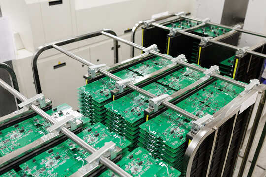 Stacks of PCB panels in antistatic rack on SMT assembly line