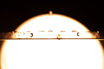330.Water Droplets on Tube with Backlit Halo Effect