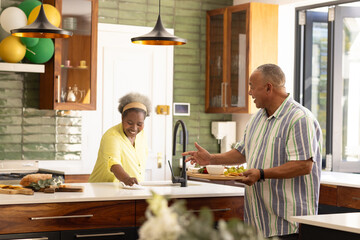African American senior couple enjoying breakfast together in modern kitchen