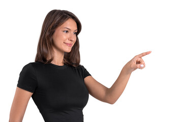 Smiling woman pointing with index finger while standing isolated on white background in cut-out...