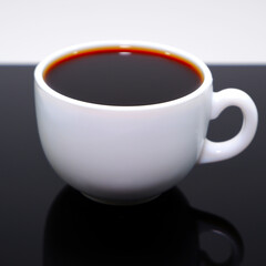 Closeup shot of a coffee cup on the black table 