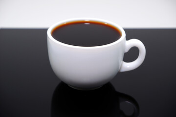 Closeup shot of a coffee cup on black table 