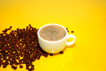 cup of coffee with beans yellow background 