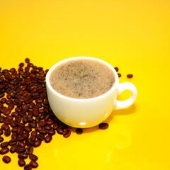 cup of coffee with beans closeup shot on yellow background 
