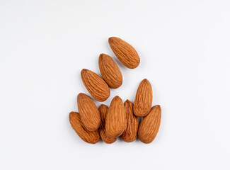 Almonds pile isolated, nut group, almond seeds, brown scattered fruit kernels on white background