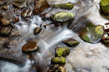 Slow shutter of the river flowing between rocks, in Keelung city, Taiwan.