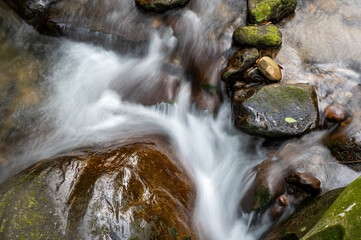Slow shutter of the river flowing between rocks, in Keelung city, Taiwan.