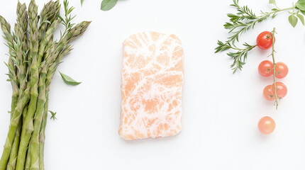 Frozen Salmon Fillet with Fresh Asparagus and Cherry Tomatoes on White Background