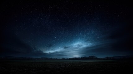Obraz premium Dramatic starry horizon glowing with soft nebula light, featuring an empty dark sky that provides ample copy space for text, logos, or design elements, capturing a stunning cosmic nighttime scene.