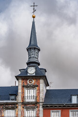 Ornate clock tower with slate spire and golden sphere finial, part of Casa de la Panaderia in Plaza Mayor, Madrid, Spain