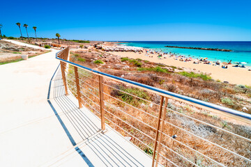 View from Paphos seaside promenade on Turquoise waters Mediterranean Sea, Venus Beach with relaxing tourists. The most beautiful beaches on holiday island  Cyprus, Paphos. © Tomasz