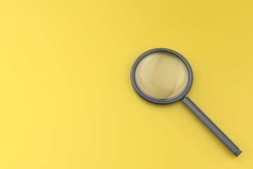 Magnifying glass on a yellow desk