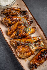 Grilled chicken wings with herbs and sauce
