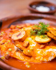 Huevos Motuleños are a Mexican breakfast, typical of the city of Motul, Yucatán. The dish is based on a fried tortilla with refried black beans and a fried egg on top.