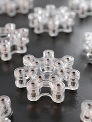 Clear Plastic Game Pieces Arranged on a Dark Surface Showcasing Intricate Designs and Textures While Highlighting Their Unique Shapes and Transparency