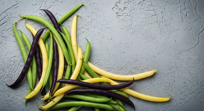 Fresh colorful green yellow and purple string beans on a grey background.