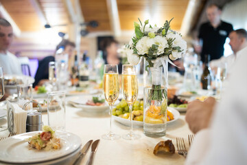 Alcohol, champagne and people at dinner party for celebration, social event and gathering. Glass, luxury and men and women with liquor for cheers, toast and drinks at gala, new years eve or wedding