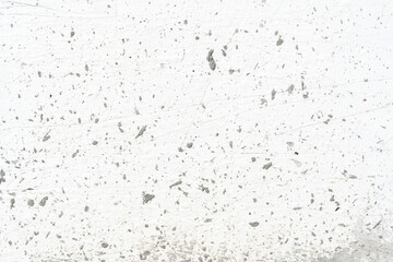 Artistic photo of old textured white wall with paint damage and concrete drops