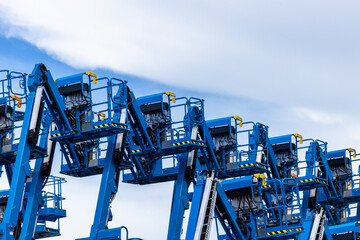 Articulate boom lift with blue sky background, Aerial platform lift telescopic boom lift hydraulic boom lift, Mobile construction crane, Construction boom lifts