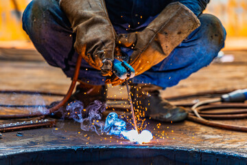 Welding male worker metal is part of machinery plate bottom tank sump construction