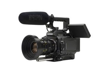 Professional video camera with lens and audio accessories on a white background