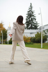 A senior woman twirls in place, smiling brightly as her coat flows. It reflects emotional well-being, freedom from judgment, and the stylish face of active aging.