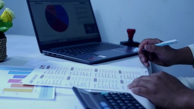 A person checks off a task list and a budget list. Checks off all the status checklist boxes and then signs them. The concept of checking and approving
