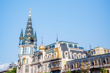 Fototapeta premium A stunning view of Batumi’s Astronomical Clock Tower and surrounding historic buildings in Georgia. The pointed spires, golden domes, and intricate European-style unique design of Georgian cultures