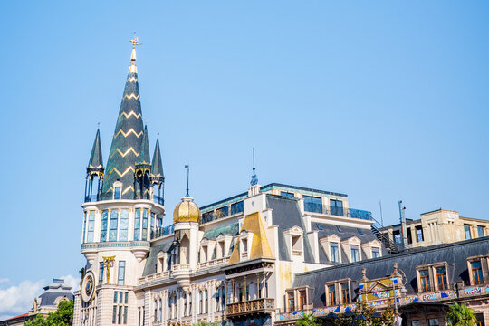 A stunning view of Batumi’s Astronomical Clock Tower and surrounding historic buildings in Georgia. The pointed spires, golden domes, and intricate European-style unique design of Georgian cultures - Powered by Adobe