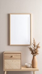 Fototapeta premium Empty Wooden Frame on Beige Wall with Cabinet and Pampas Grass Decoration