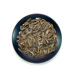 A plate full of sunflower seeds closeup view on white background