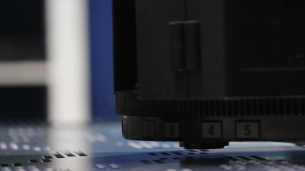 Close-up shot of specialized CNC turret punch tooling cutting patterns into sheet metal.