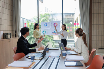 Conference table with documents, laptops, and an intense discussion.