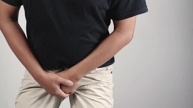 Erectile dysfunction concept. Close up of man holding his crotch. Men's health. Man holding genitals. Men's health, venereologist, sexual disease
