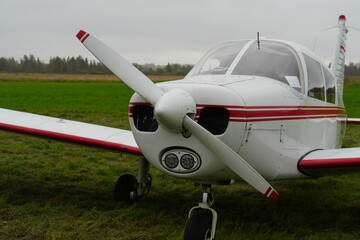 Piper Cherokee 140 Light Aircraft on a Grassy Airfield