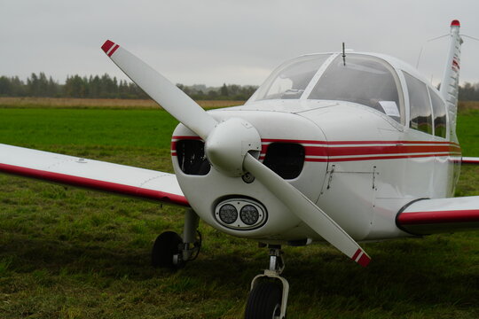 Piper Cherokee 140 Light Aircraft on a Grassy Airfield