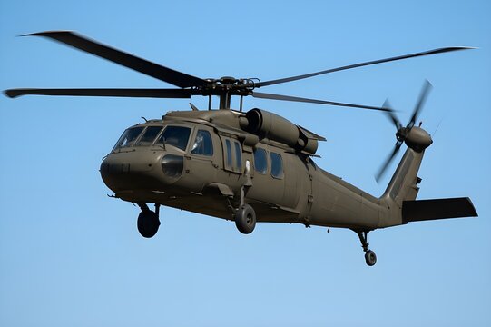 Sikorsky UH-60 Black Hawk Helicopter in Flight
​A Sikorsky UH-60 Black Hawk helicopter, painted in a matte olive drab color, is shown in flight against a clear, deep blue sky.