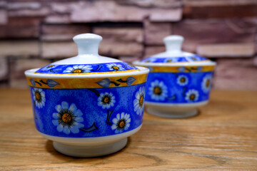 floral pattern ceramic jar together closeup view selective focused blurry background