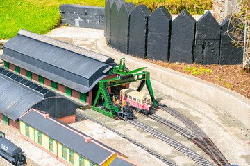 Model train pulling into depot in toy town