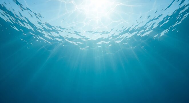 Serene underwater shot with sun rays filtering through ocean surface. Ideal for travel, summer, marine biology, or abstract themes.  Perfect for aquatics background or visuals.