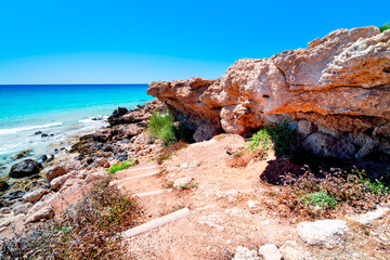 Island rocky coast with azure waters and Wreksi Beach on sunny summer day. The most beautiful...