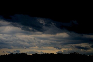 A cloud over the forest in summer