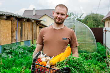 A portrait of a farmer with a crate of fresh vegetables.