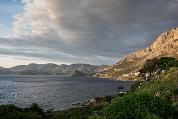 Lush and mountainous landscape and the Aegean Sea seen from Masouri (Massouri) towards north on Kalymnos island in Greece on a sunny afternoon.